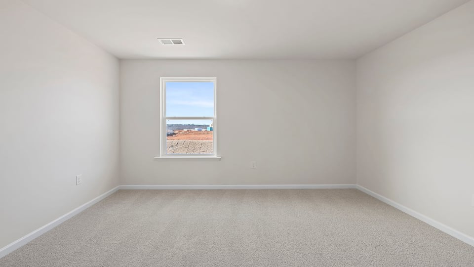 Bedroom with carpet and window.