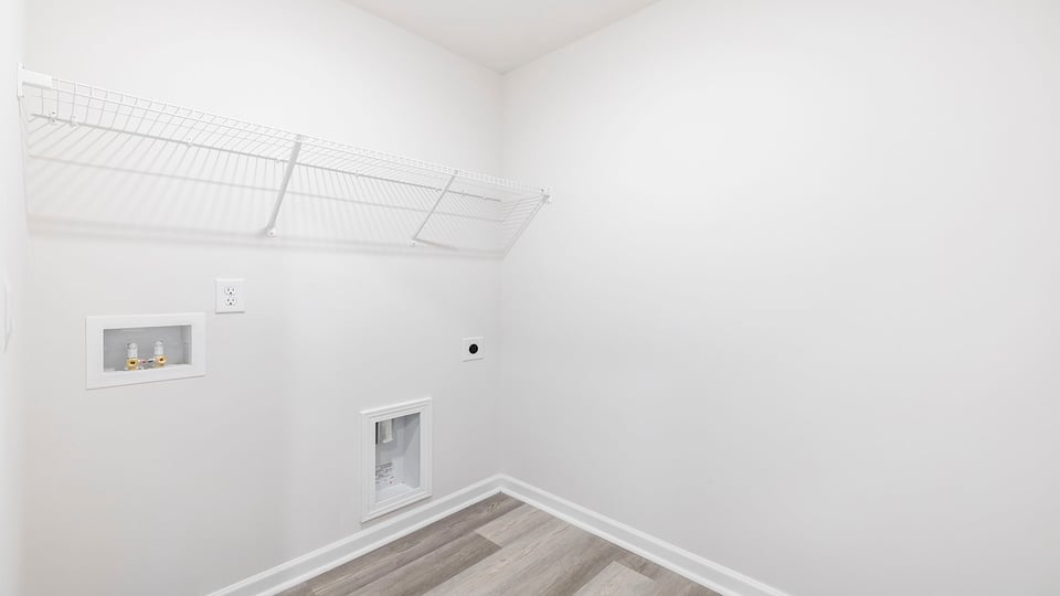 Walk in laundry with shelves.
