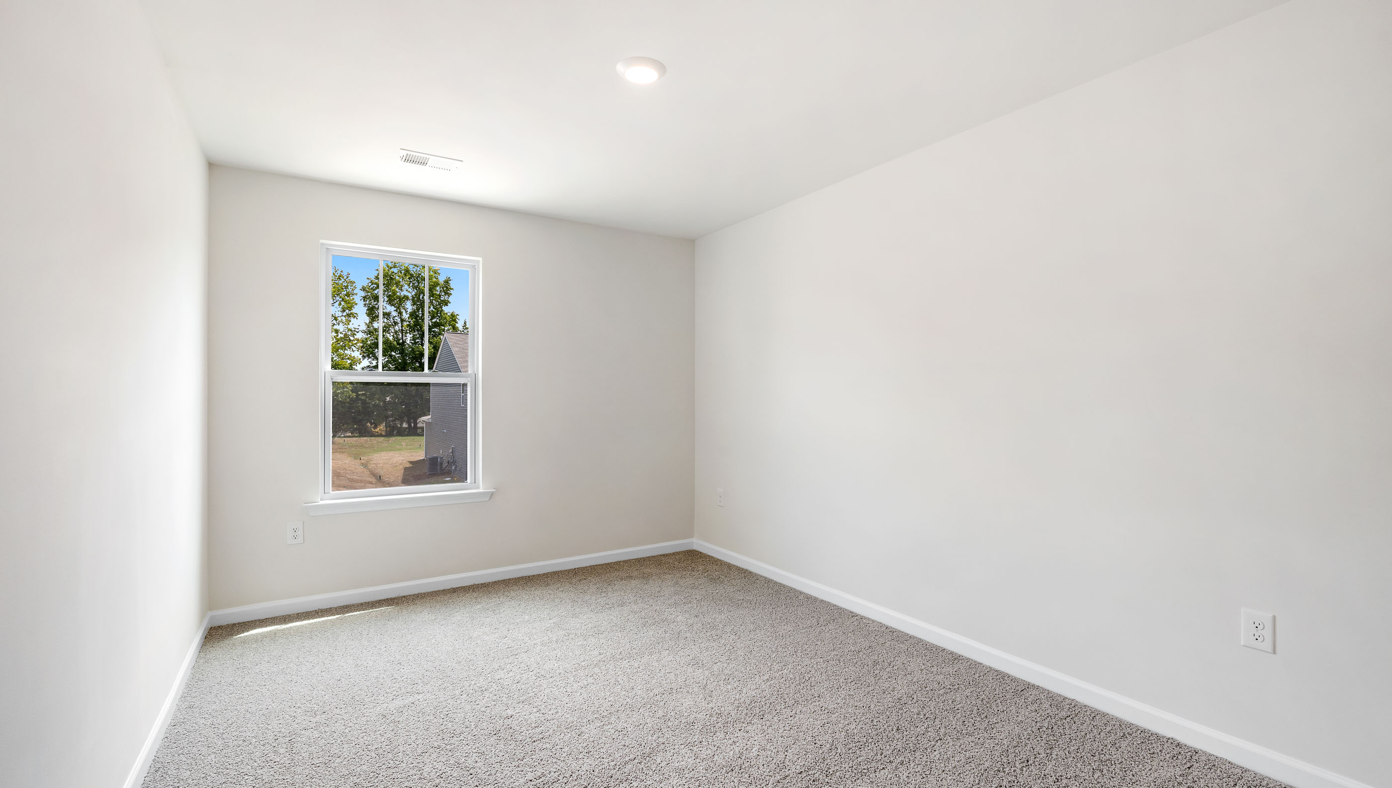 Bedroom with carpet and window.