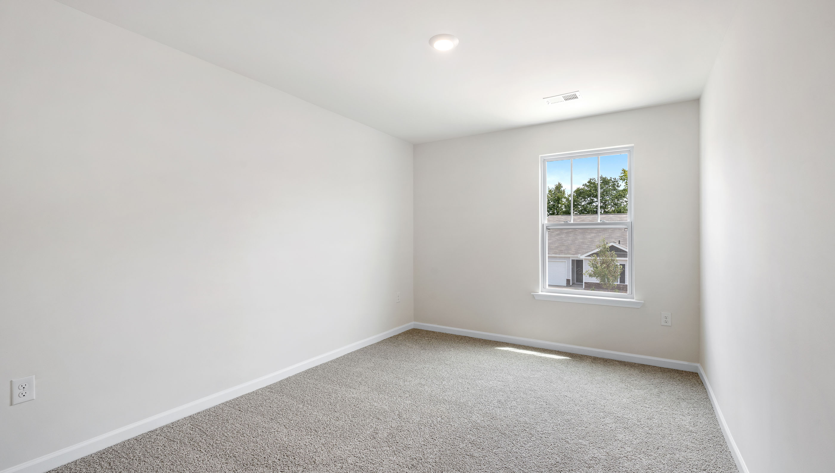 Bedroom with carpet and window.