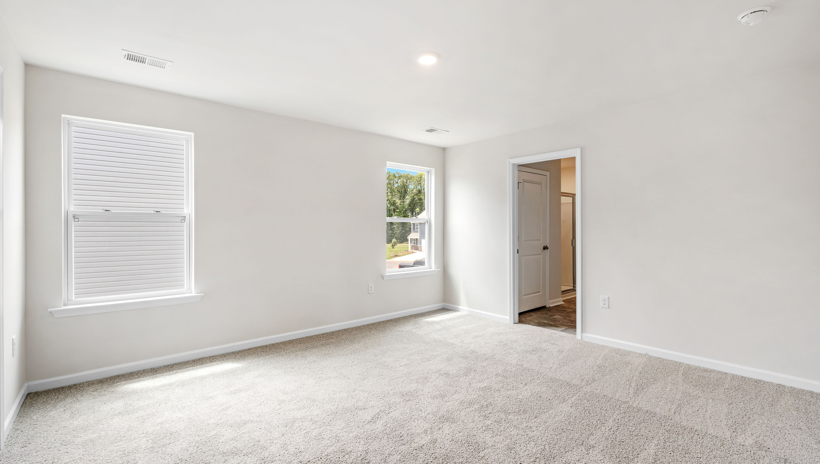Bedroom with carpet and window.
