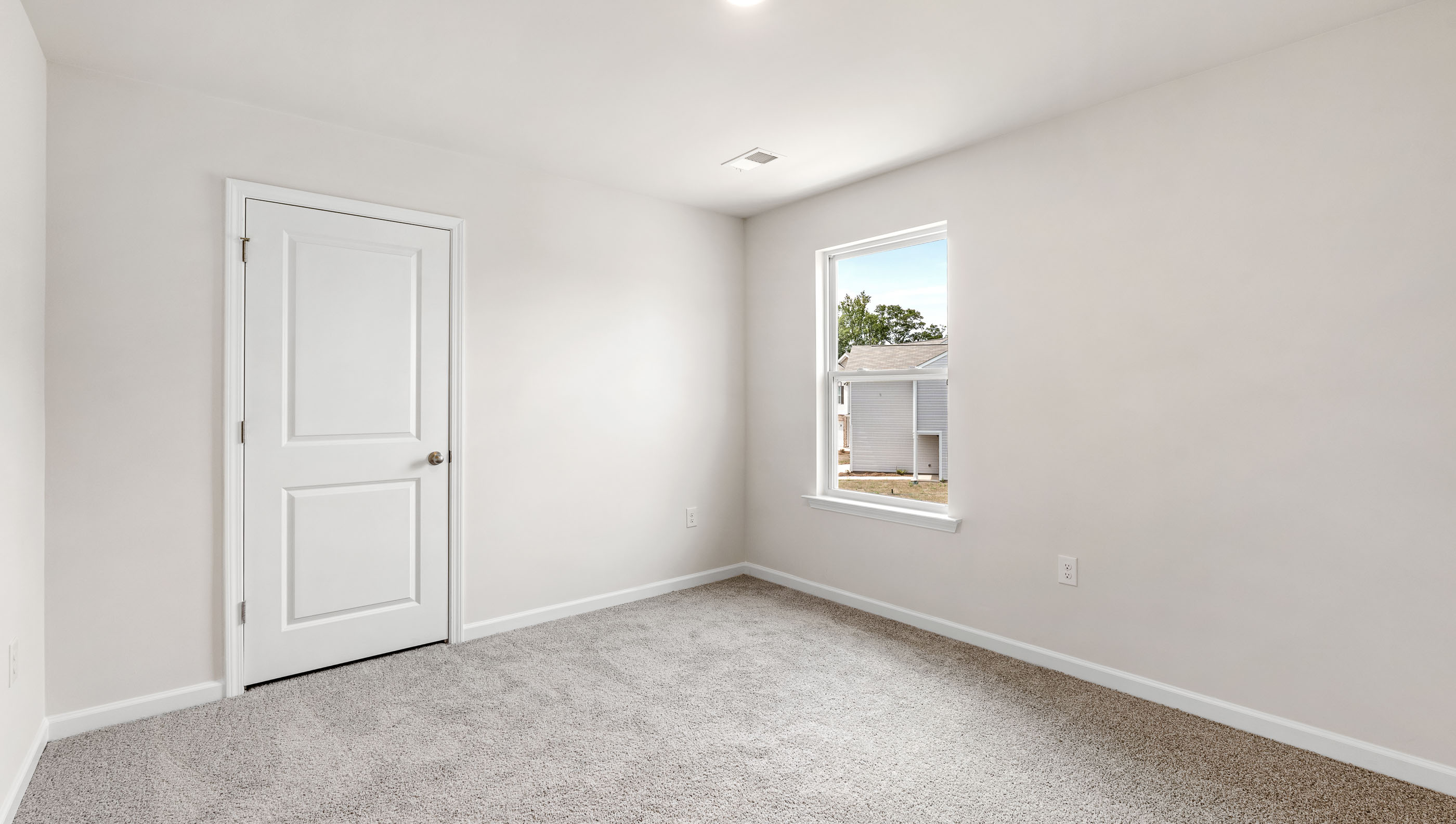 Bedroom with carpet and window.