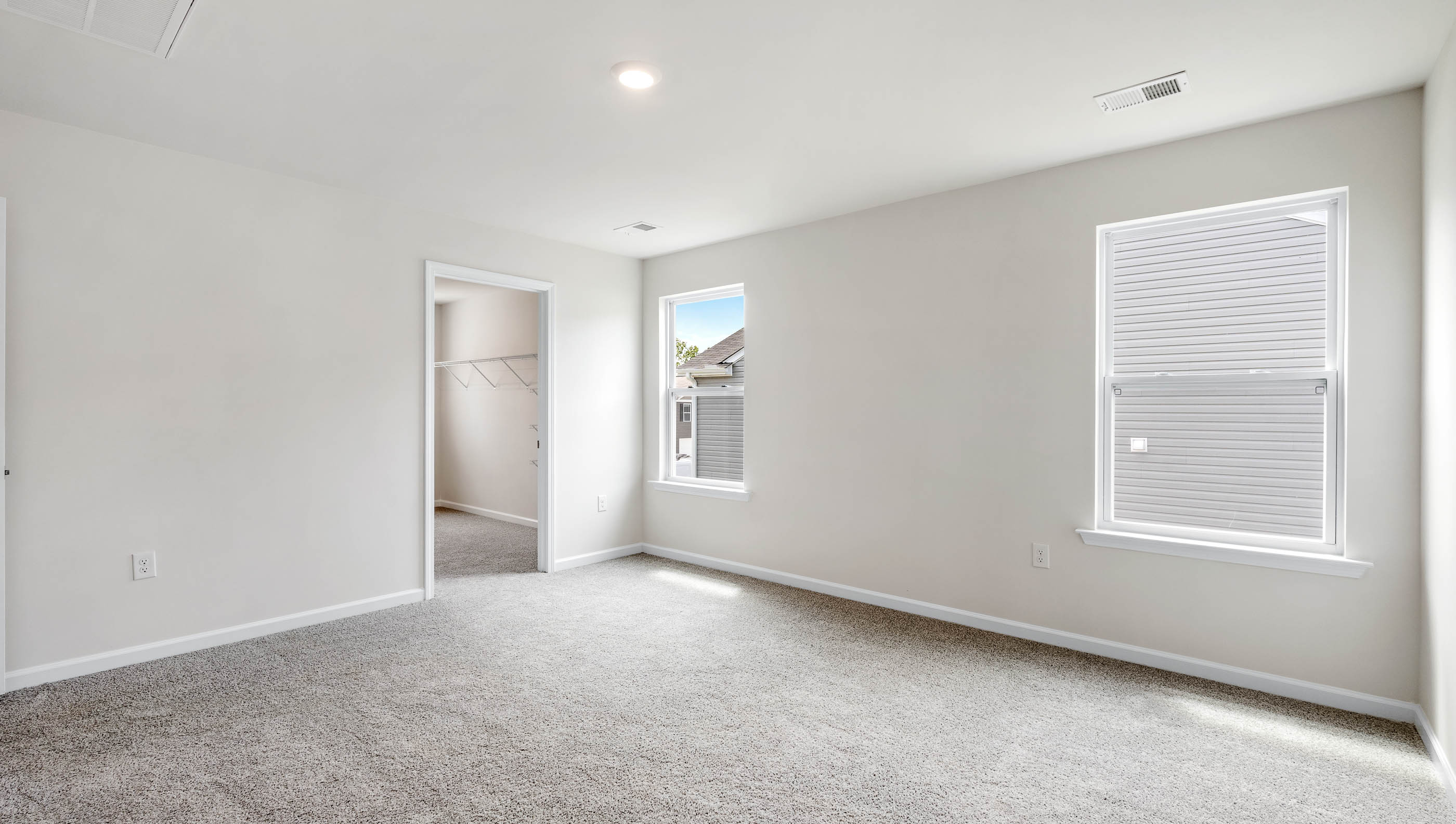 Bedroom with carpet and window.