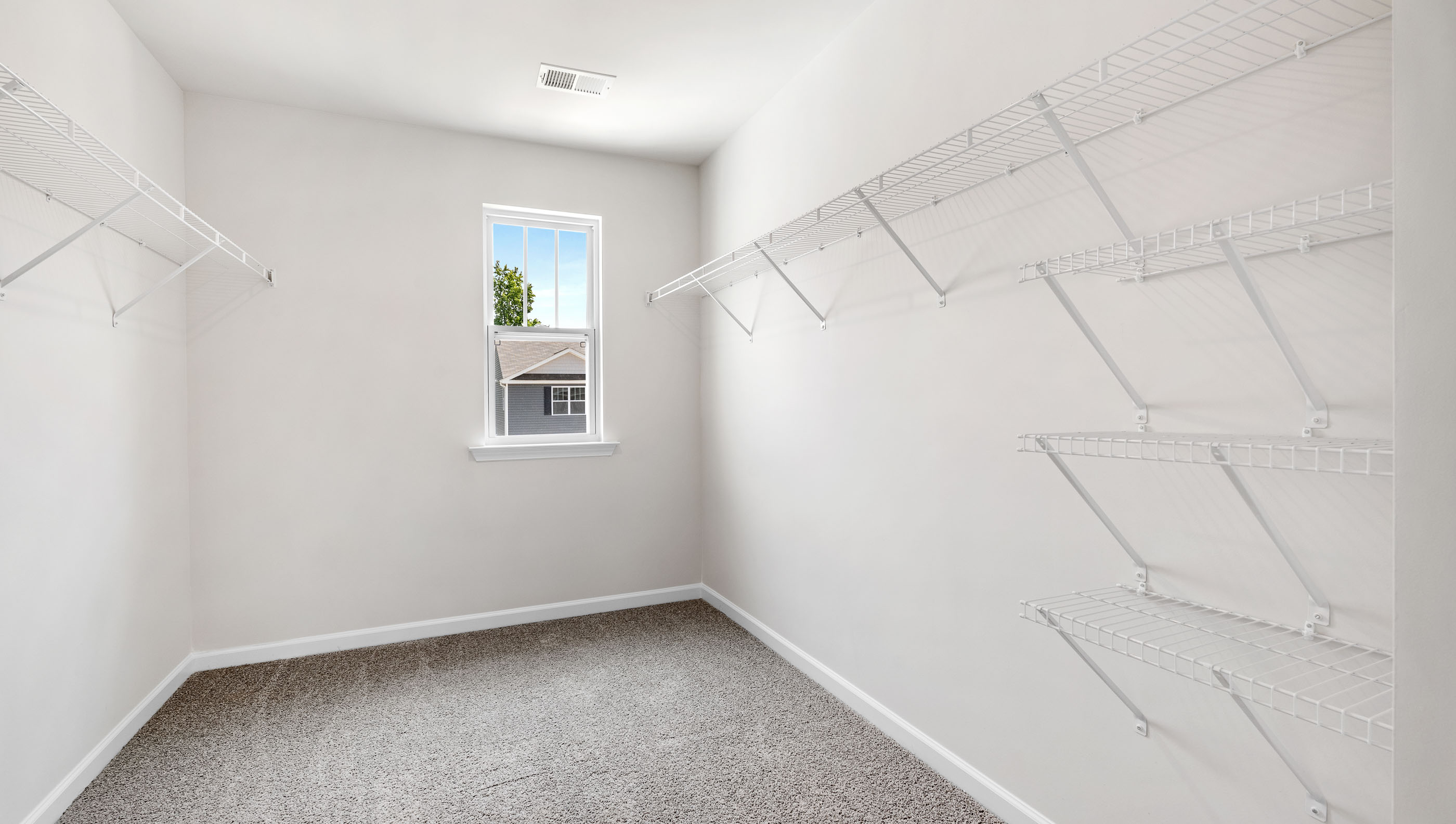 Closet with hanging storage racks.