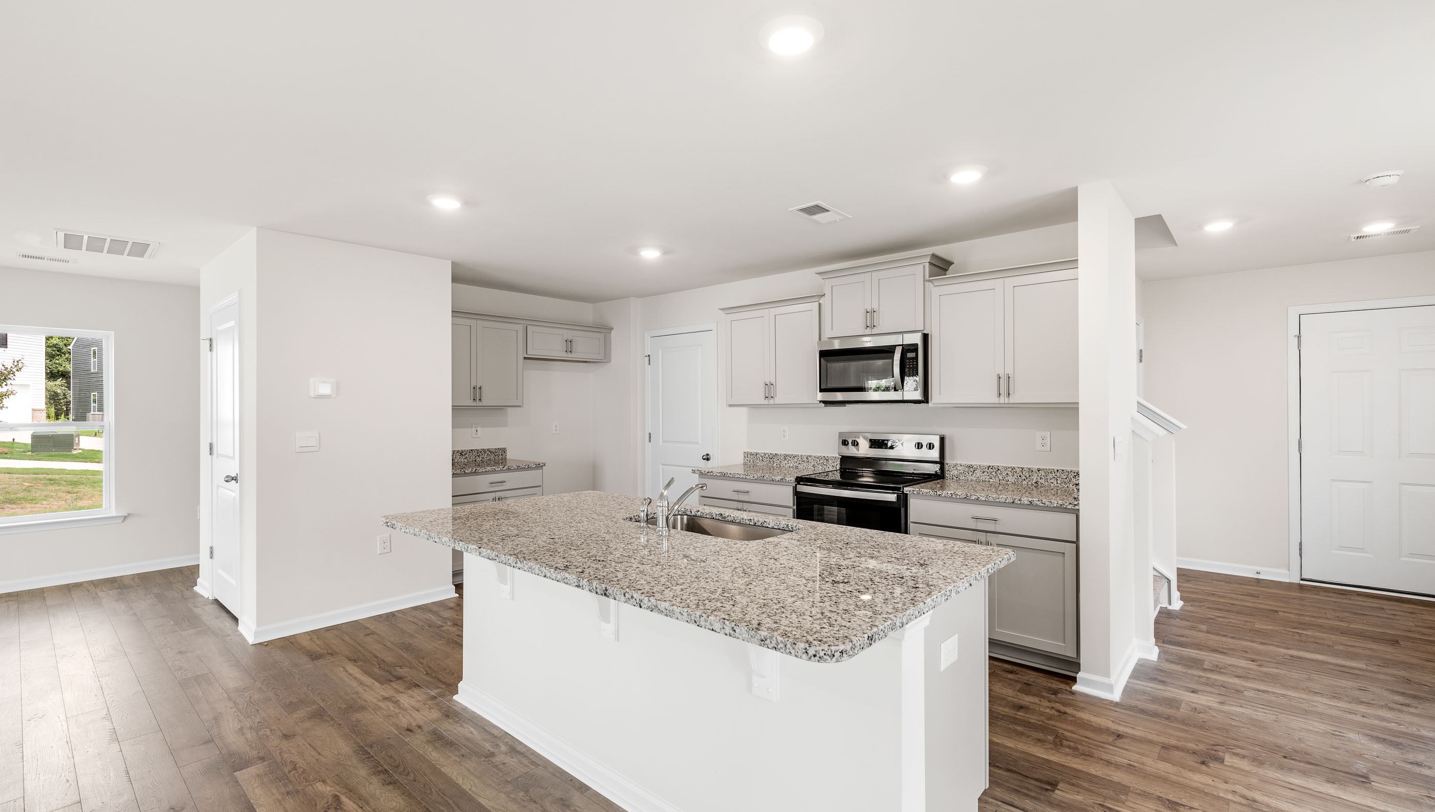 Kitchen and island with granite counter tops.