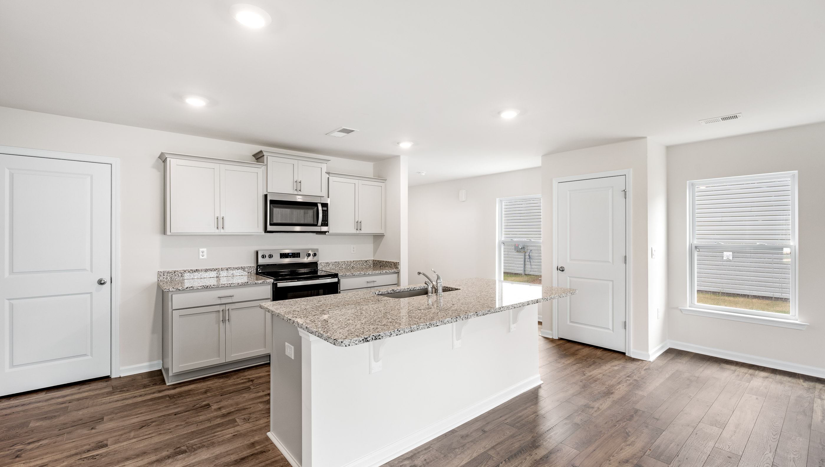 Kitchen and island with granite counter tops.