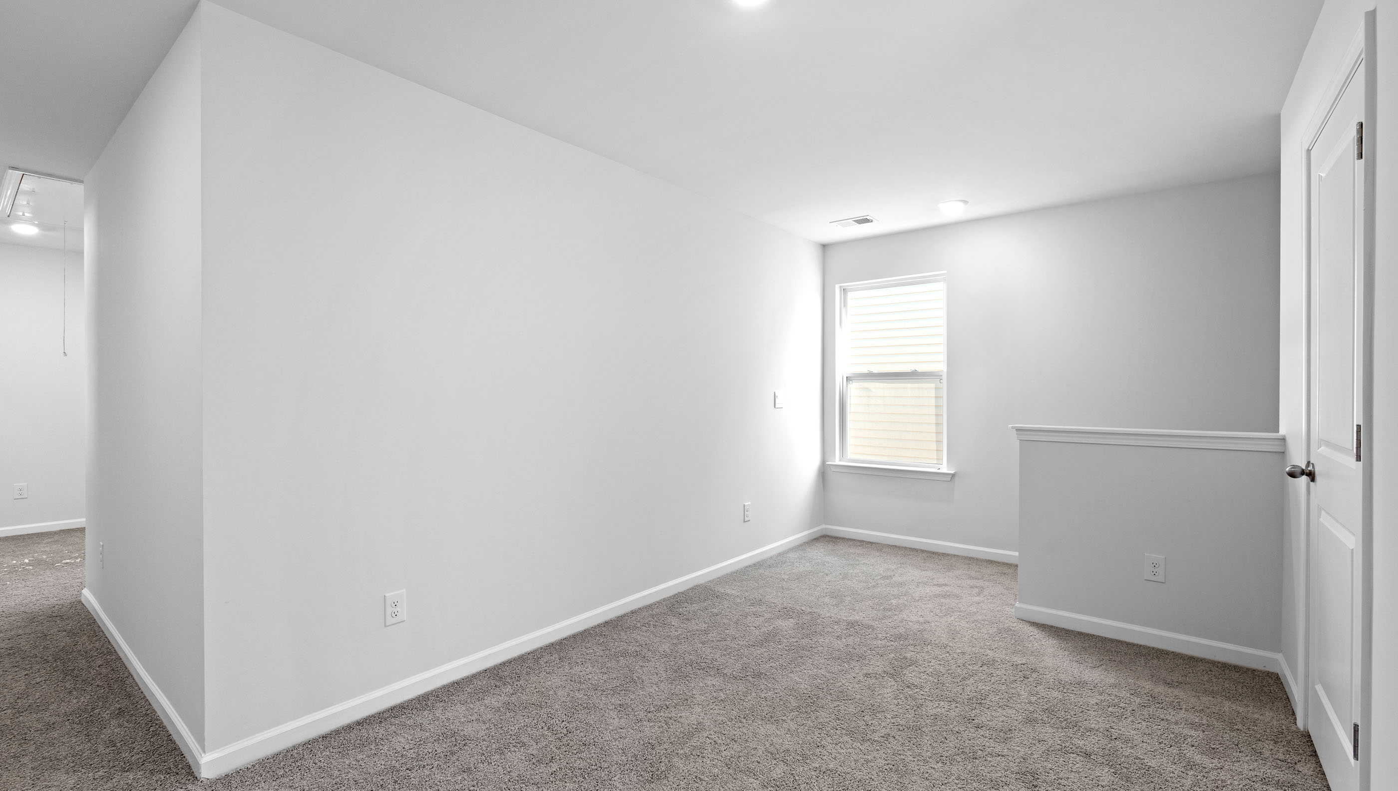 Bedroom with carpet and window.