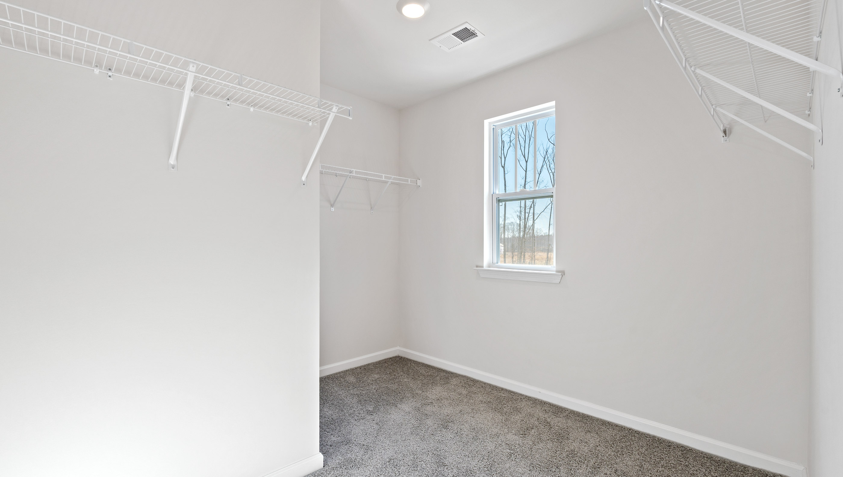 Closet with hanging storage racks.