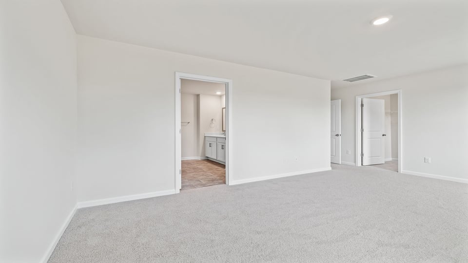 Bedroom with carpet and window.