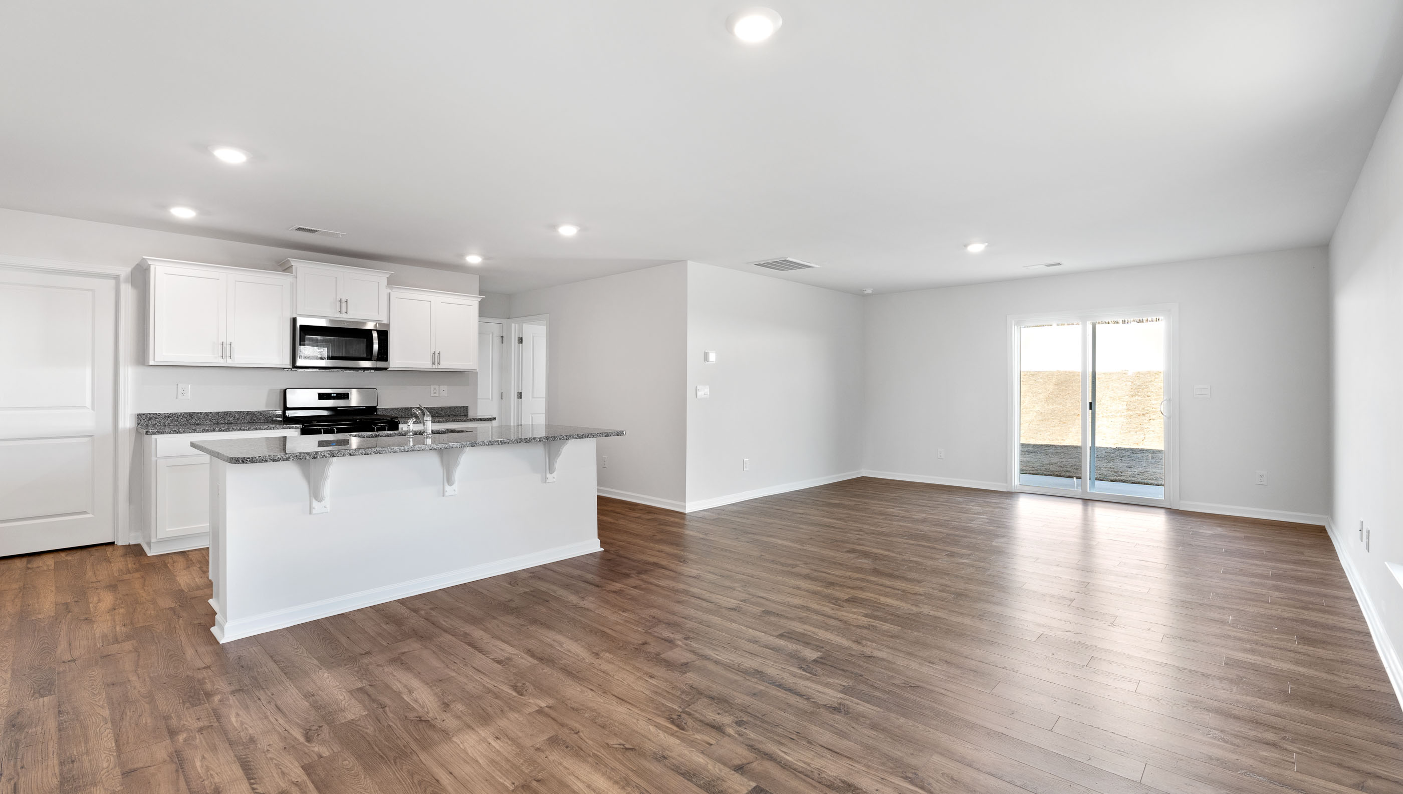 Kitchen with island and granite countertops.