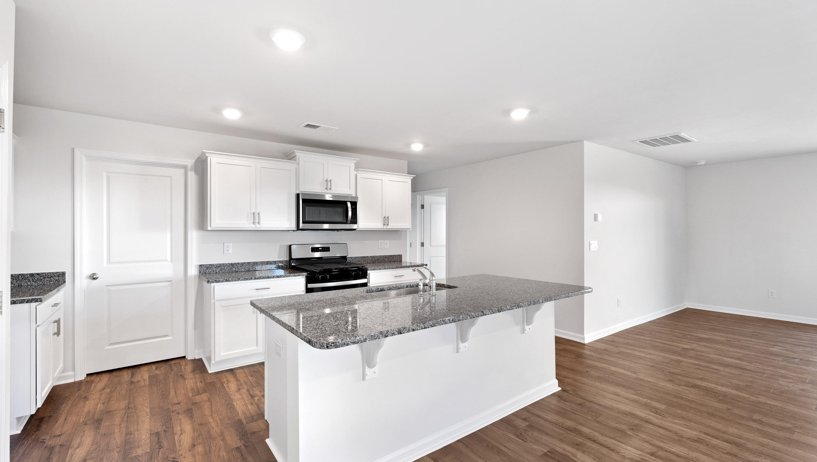Kitchen with island and granite countertops.