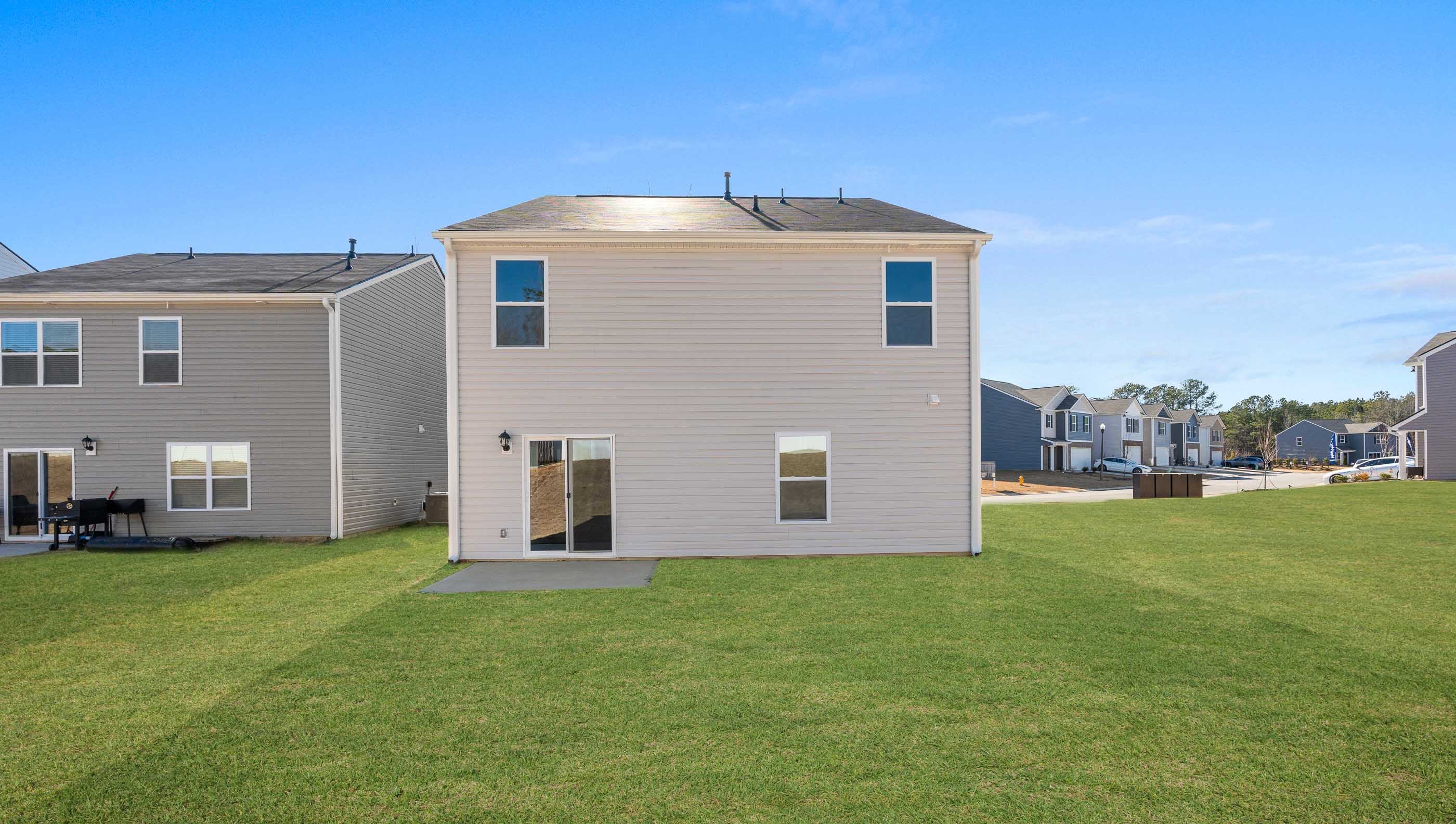 Exterior of home with large backyard.