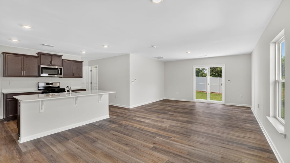 Kitchen with island and quartz countertops.