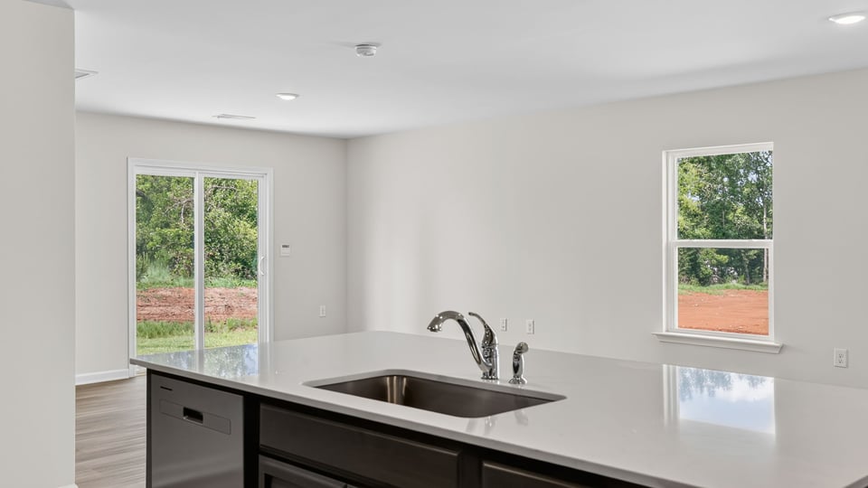 Kitchen with island and quartz countertops.