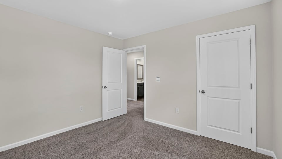 Bedroom with carpet and window.
