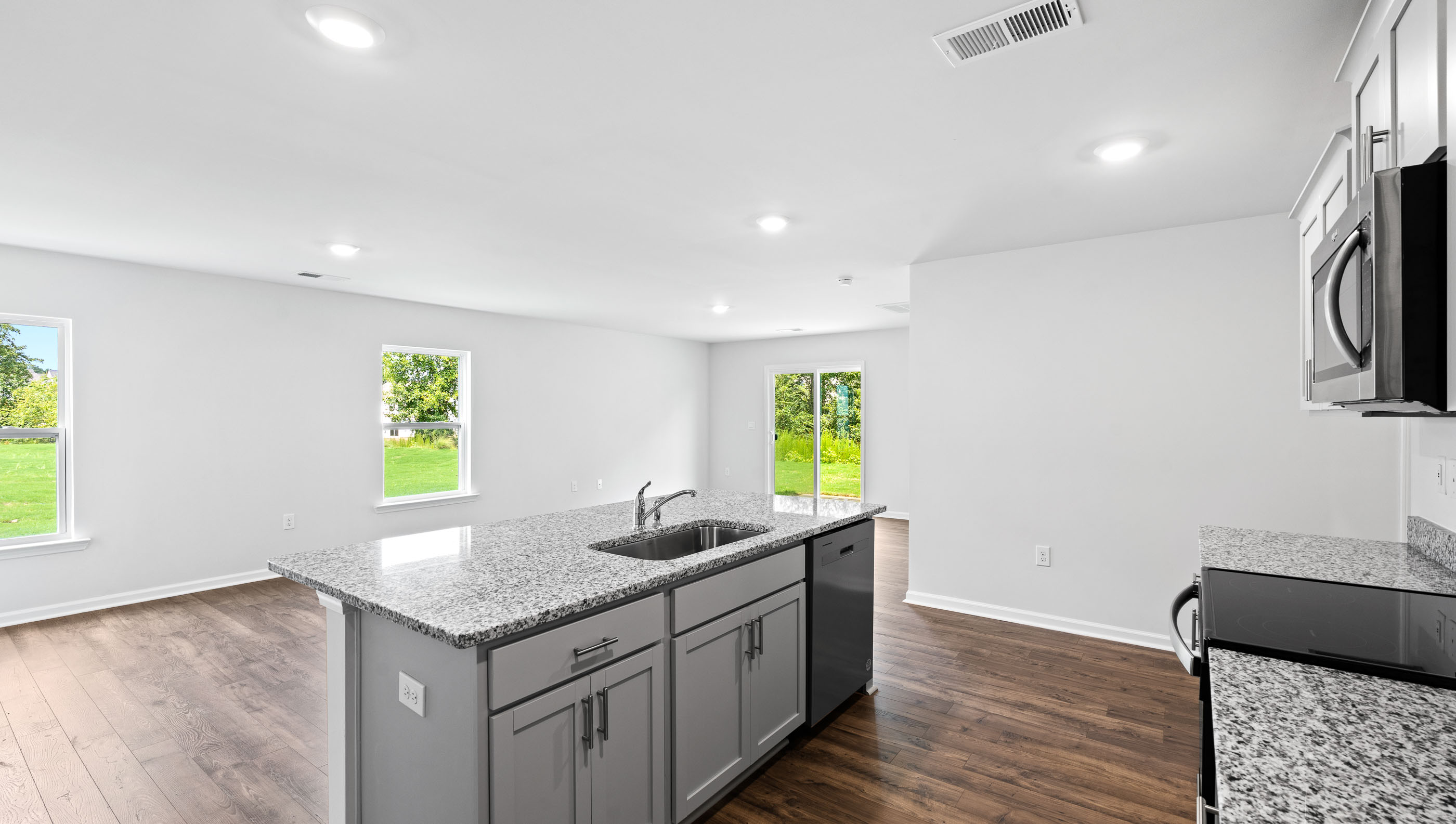 Kitchen and island with granite counter tops.