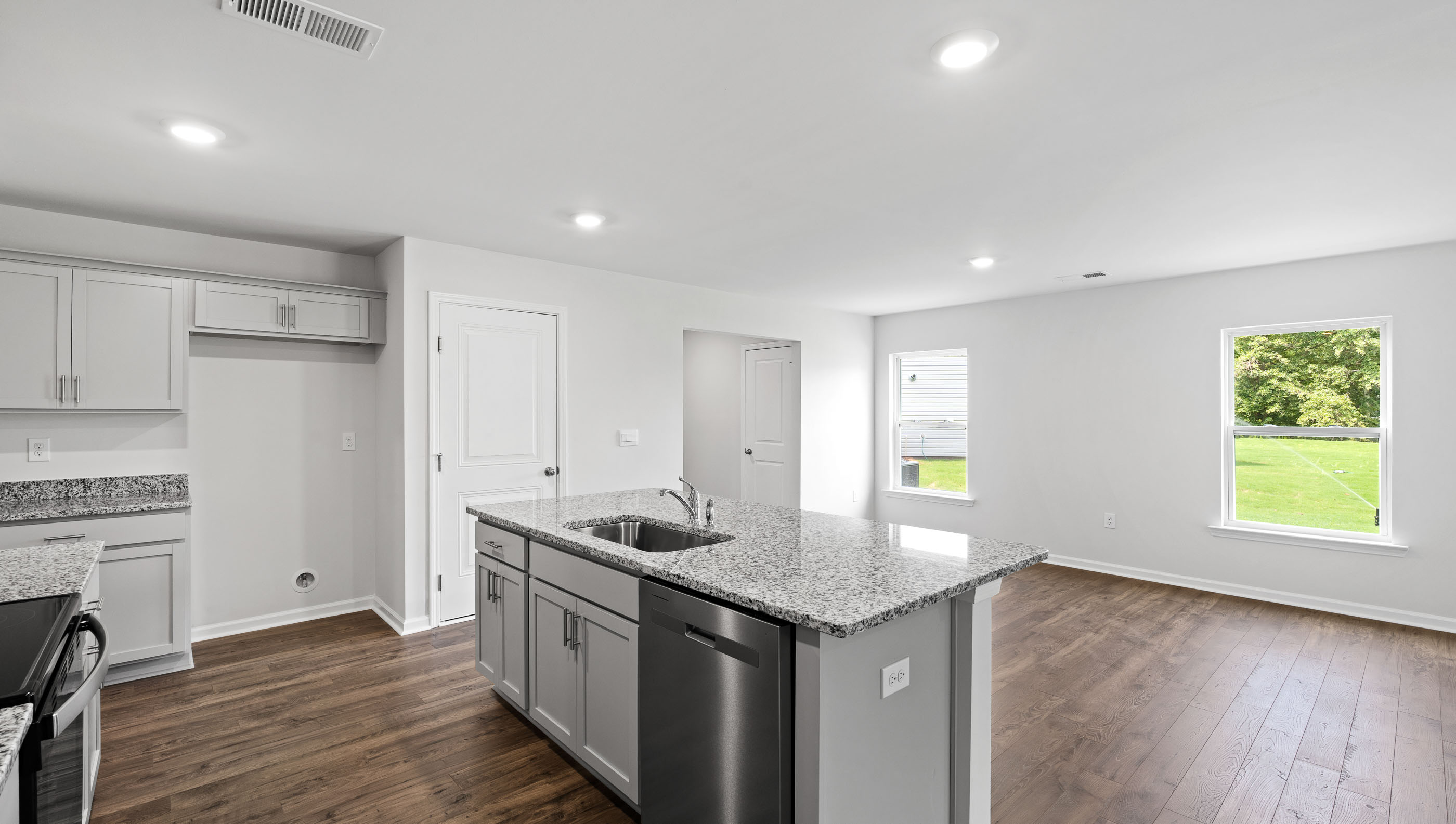 Kitchen and island with granite counter tops.