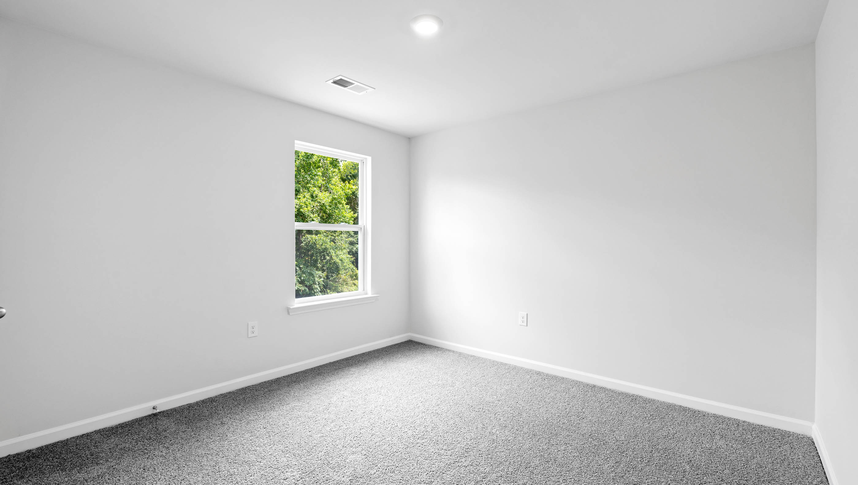 Bedroom with carpet and window.