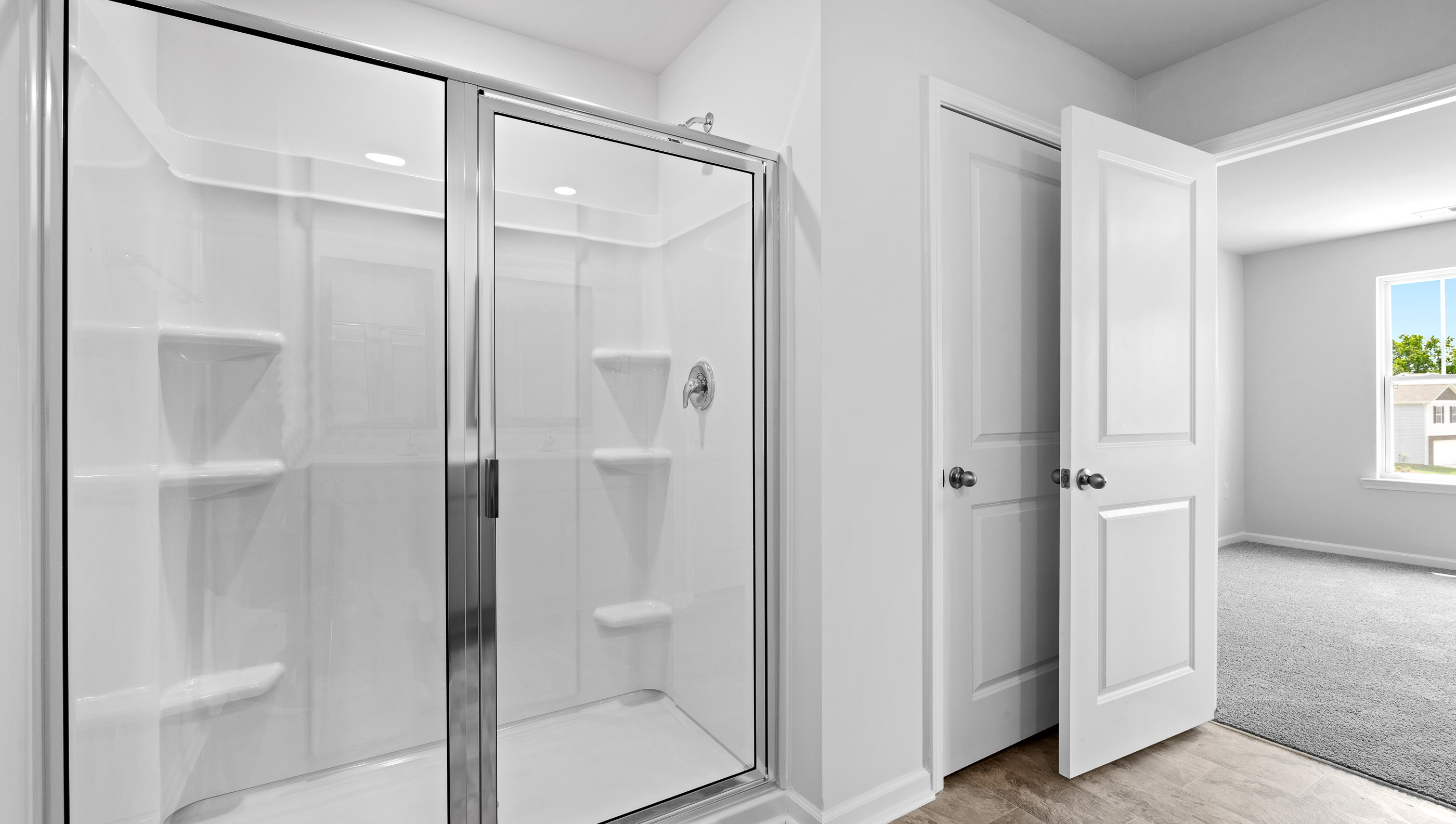 Bathroom with walk in shower and closet.