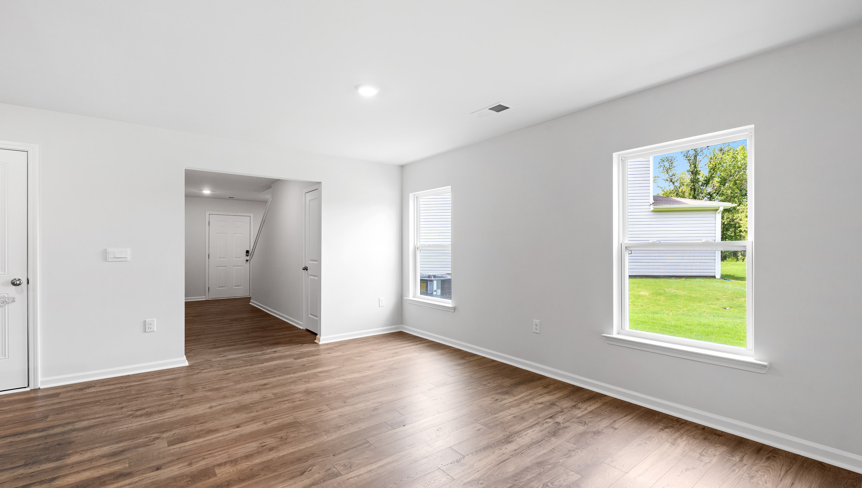 Family room with windows and door to backyard.