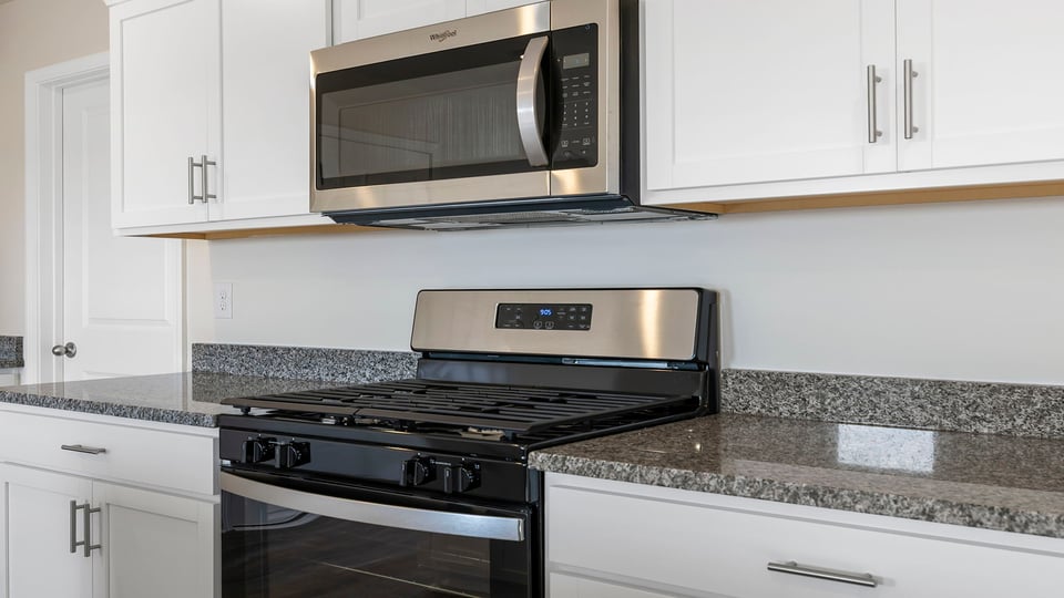 Kitchen with granite countertops and stainless steel appliances.