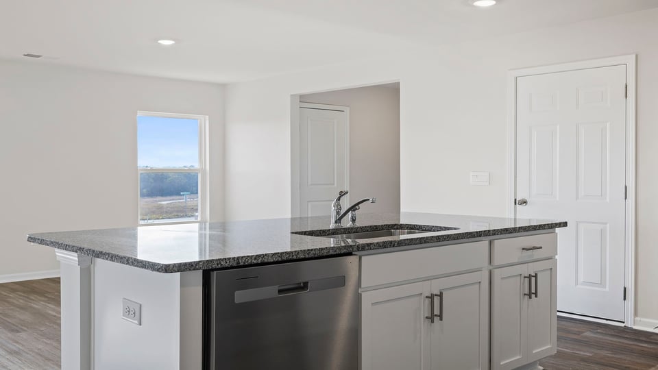 Kitchen with island and granite countertops.