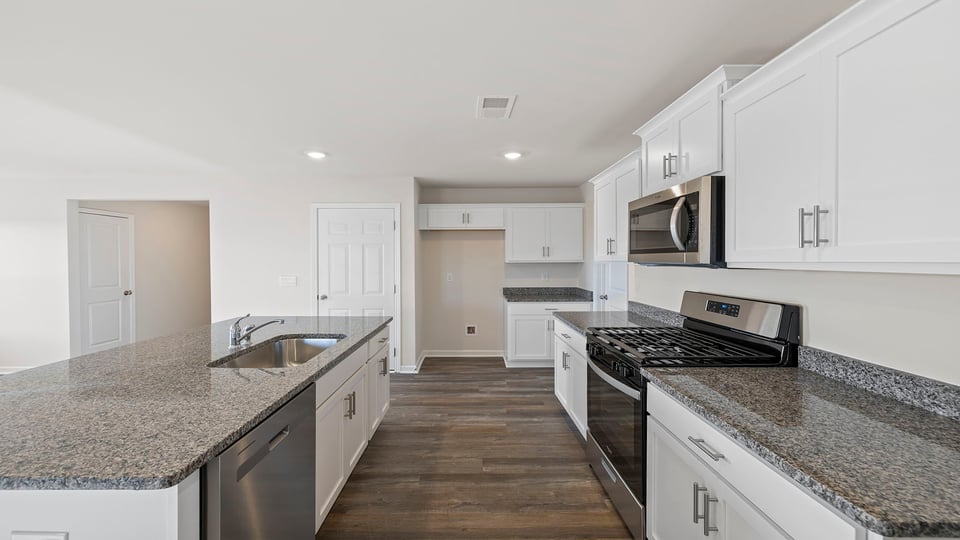 Kitchen with island and granite countertops.