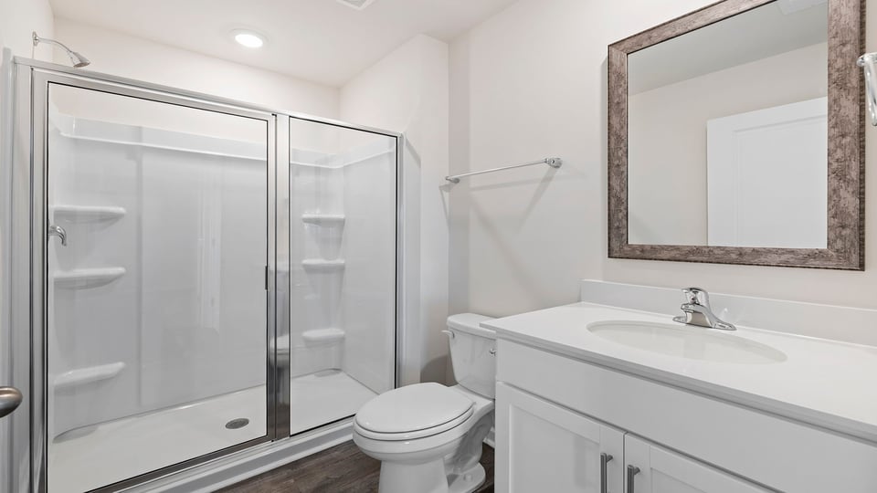 Bathroom with vanity and walk in shower.