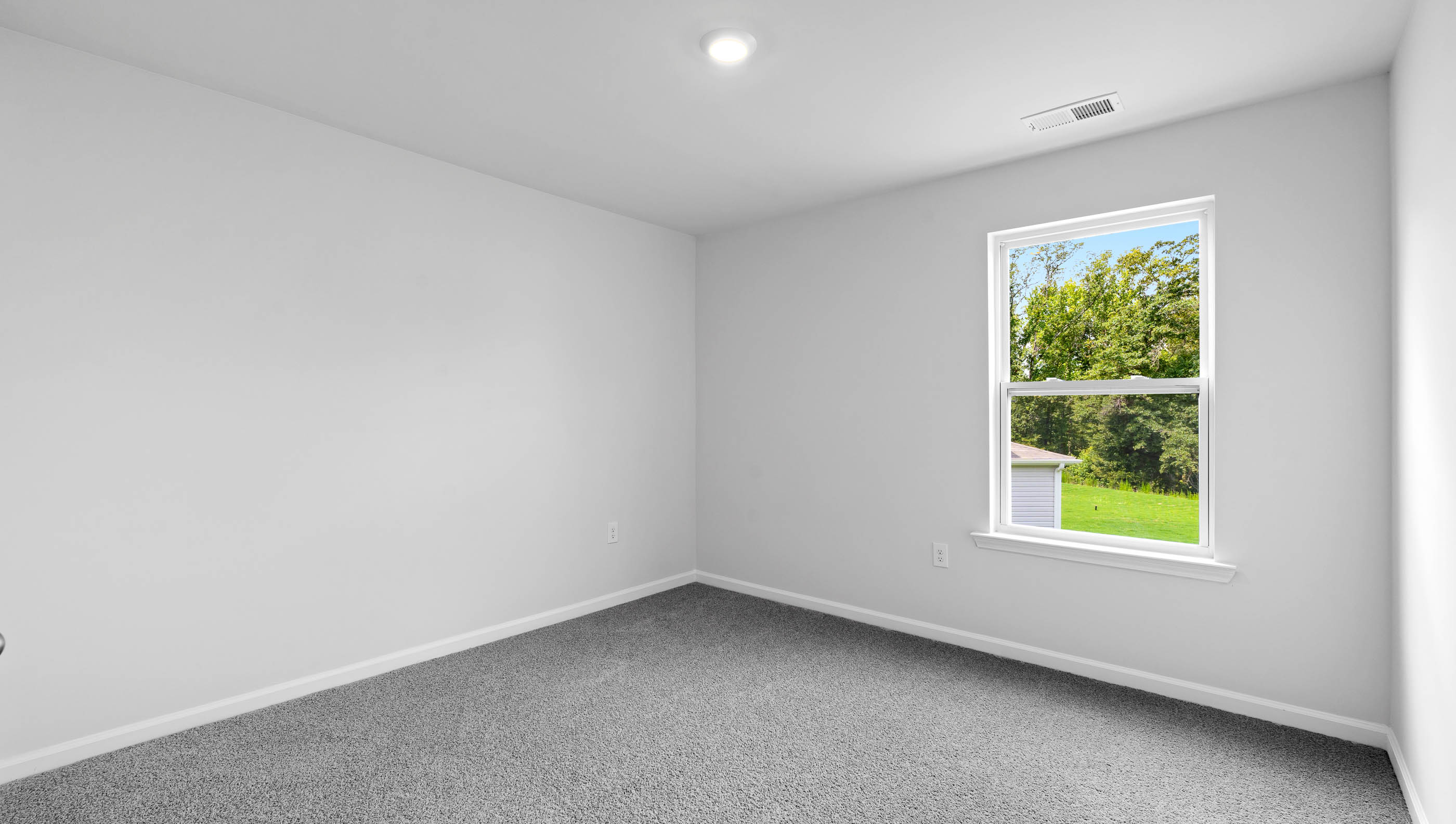 Bedroom with carpet and window.
