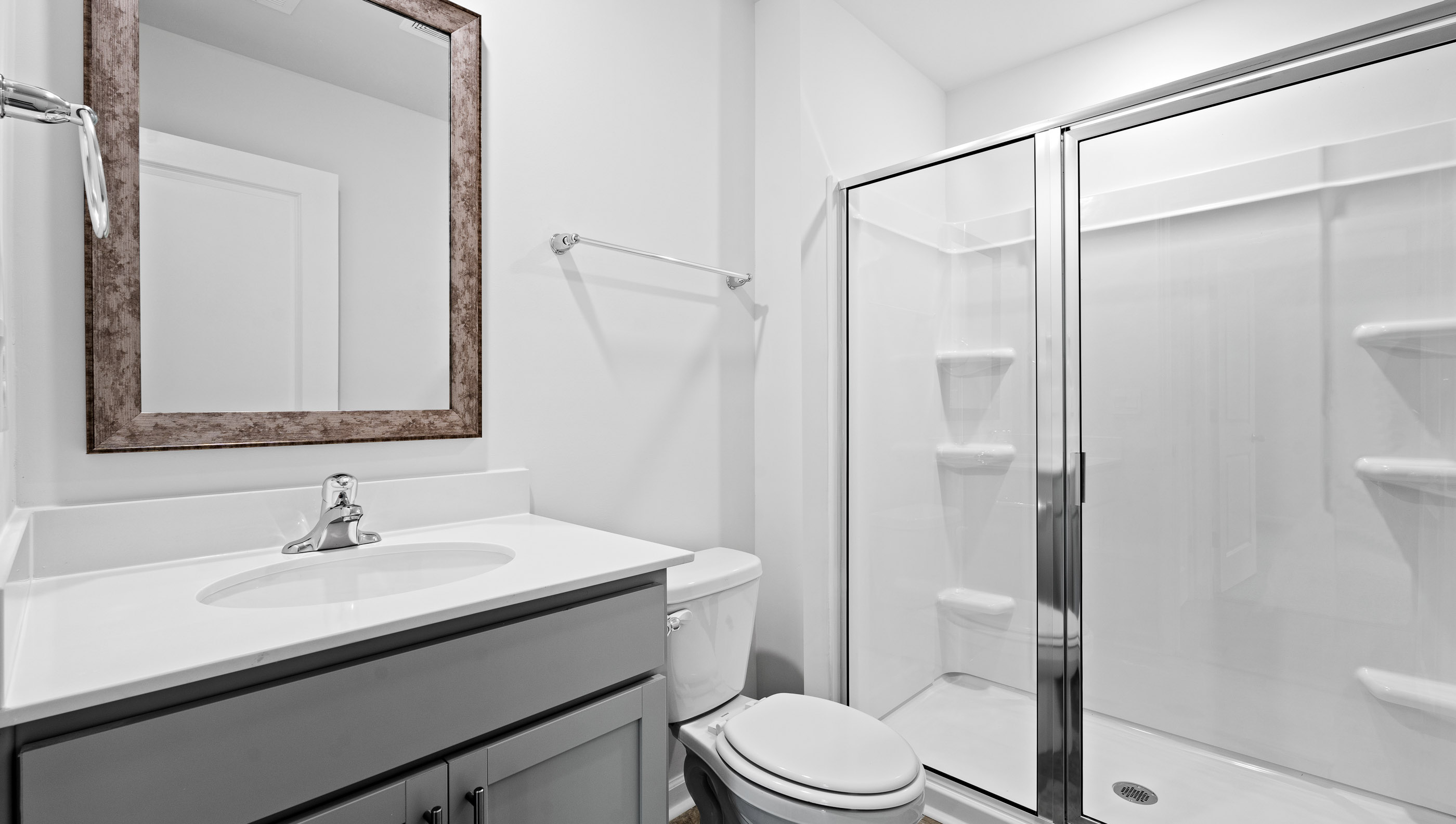Bathroom with double vanity sink and shower.