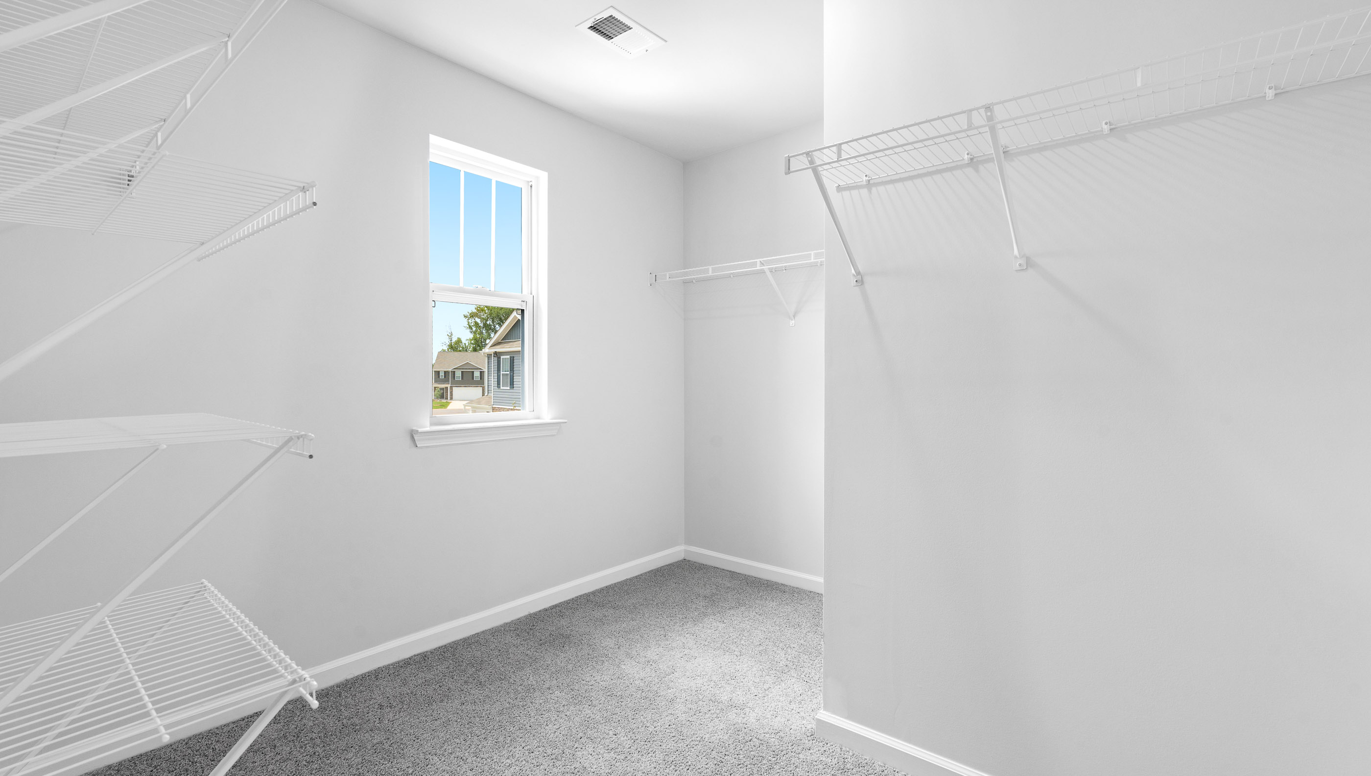 Closet with hanging storage racks.