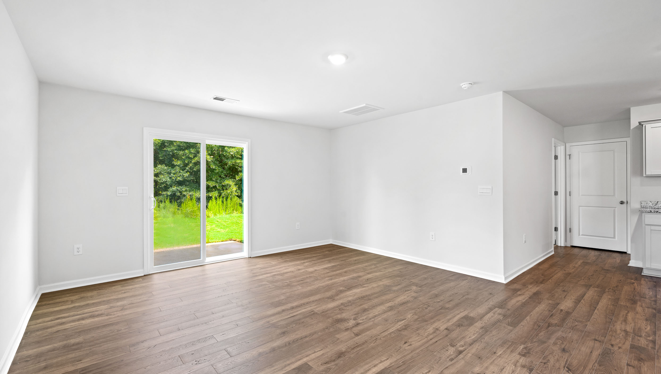 Family room with windows and door to backyard.