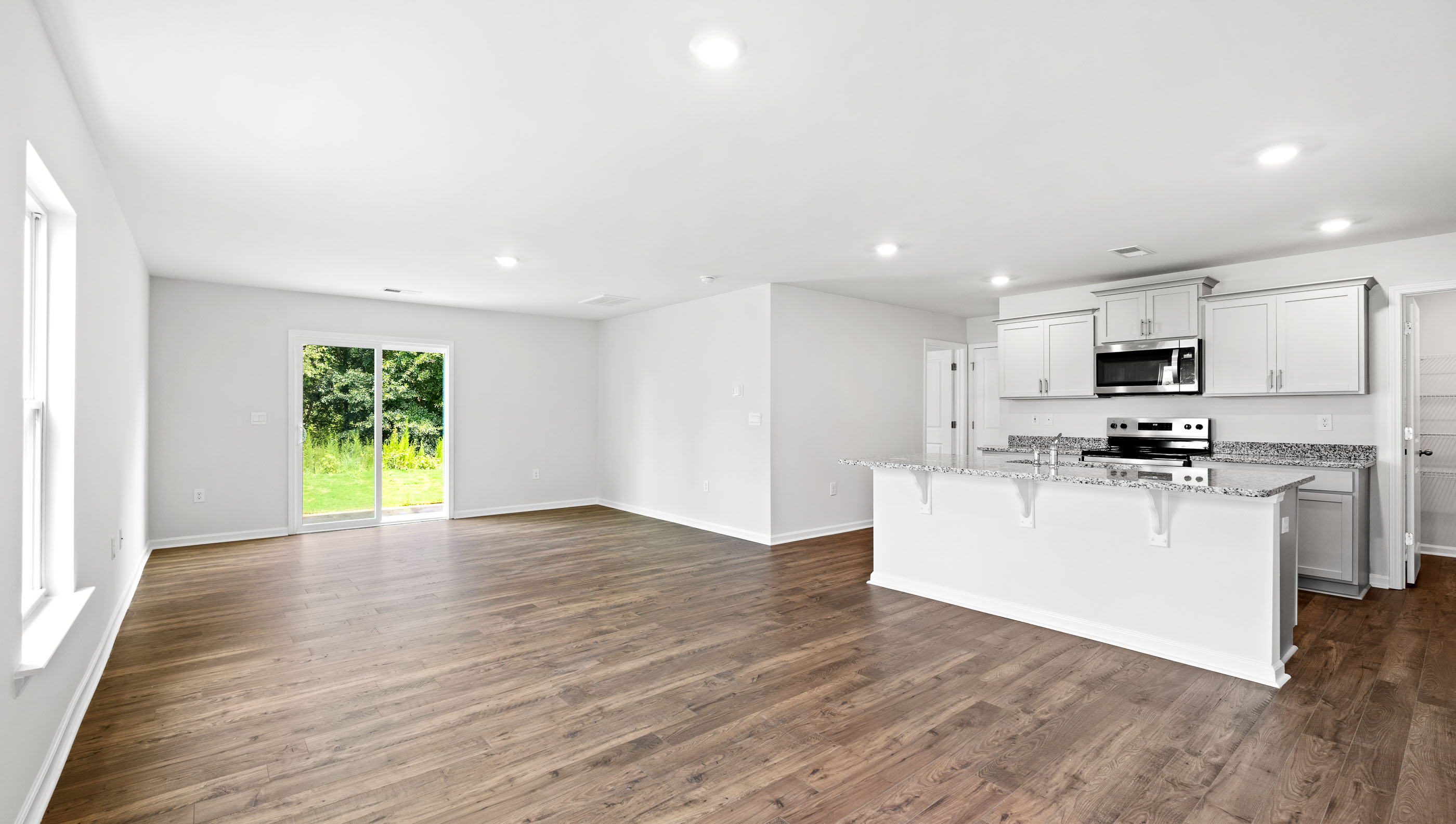 Family room with windows and door to backyard.