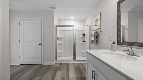 Bathroom with double vanity sink and shower.