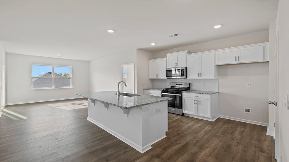 Kitchen and island with granite countertops.