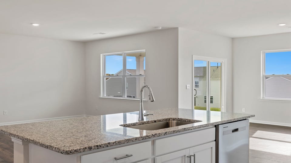Kitchen and island with granite countertops.