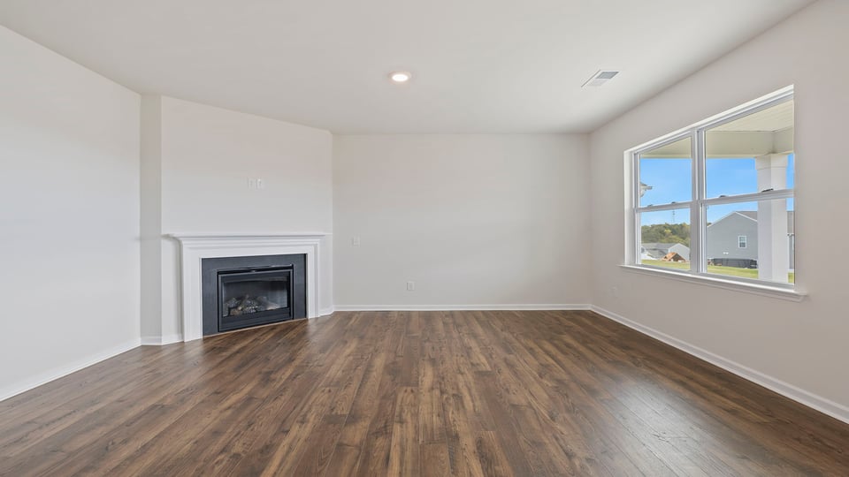 Living room with fireplace and windows.