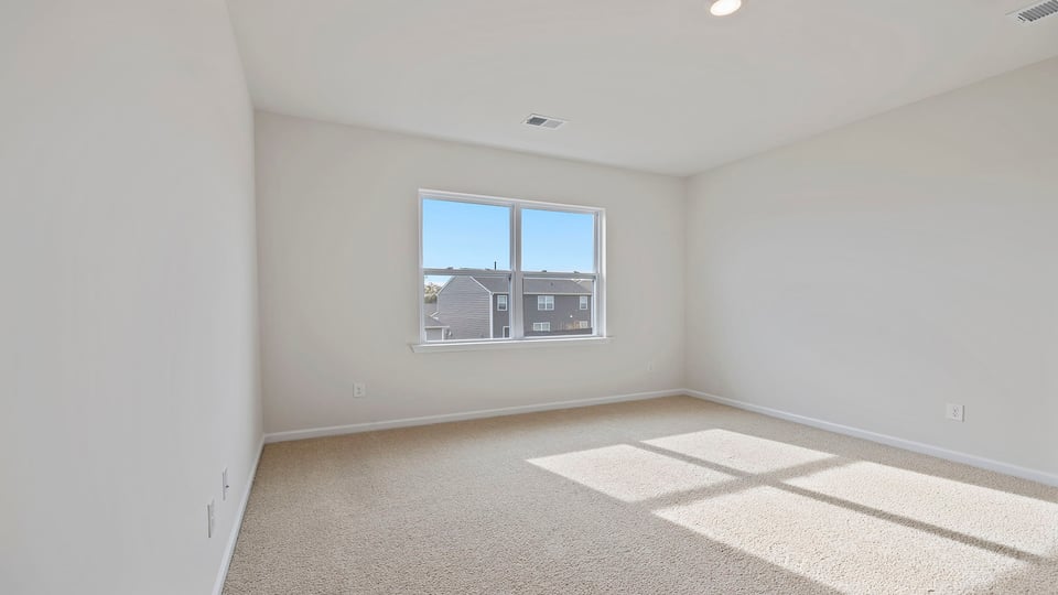 Bedroom with carpet and window.