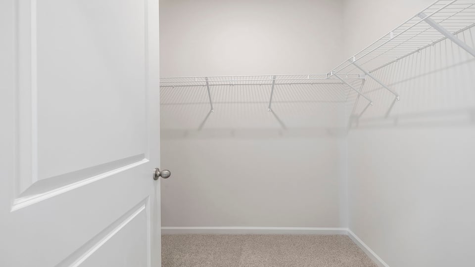 Walk in closet with shelves.