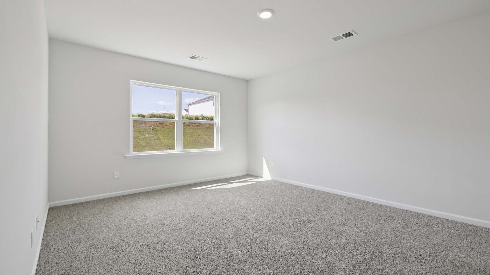Bedroom with carpet and windows.