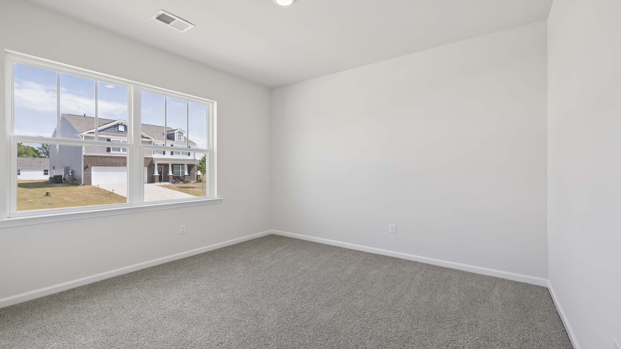 Bedroom with carpet and windows.