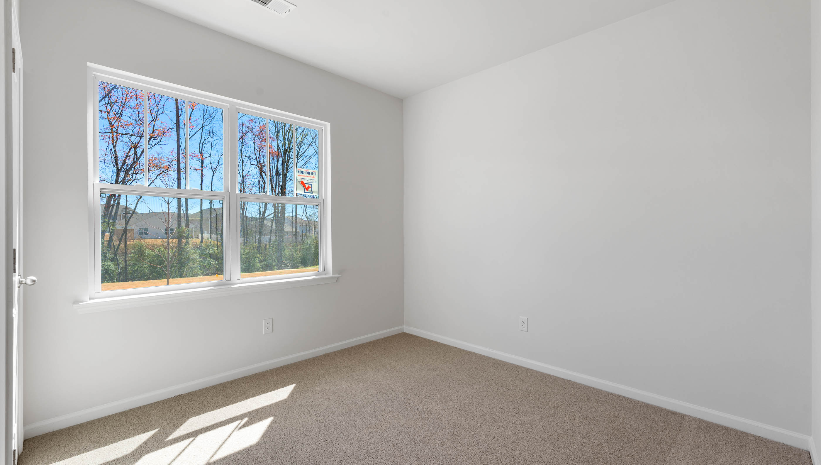 Bedroom with carpet and window.