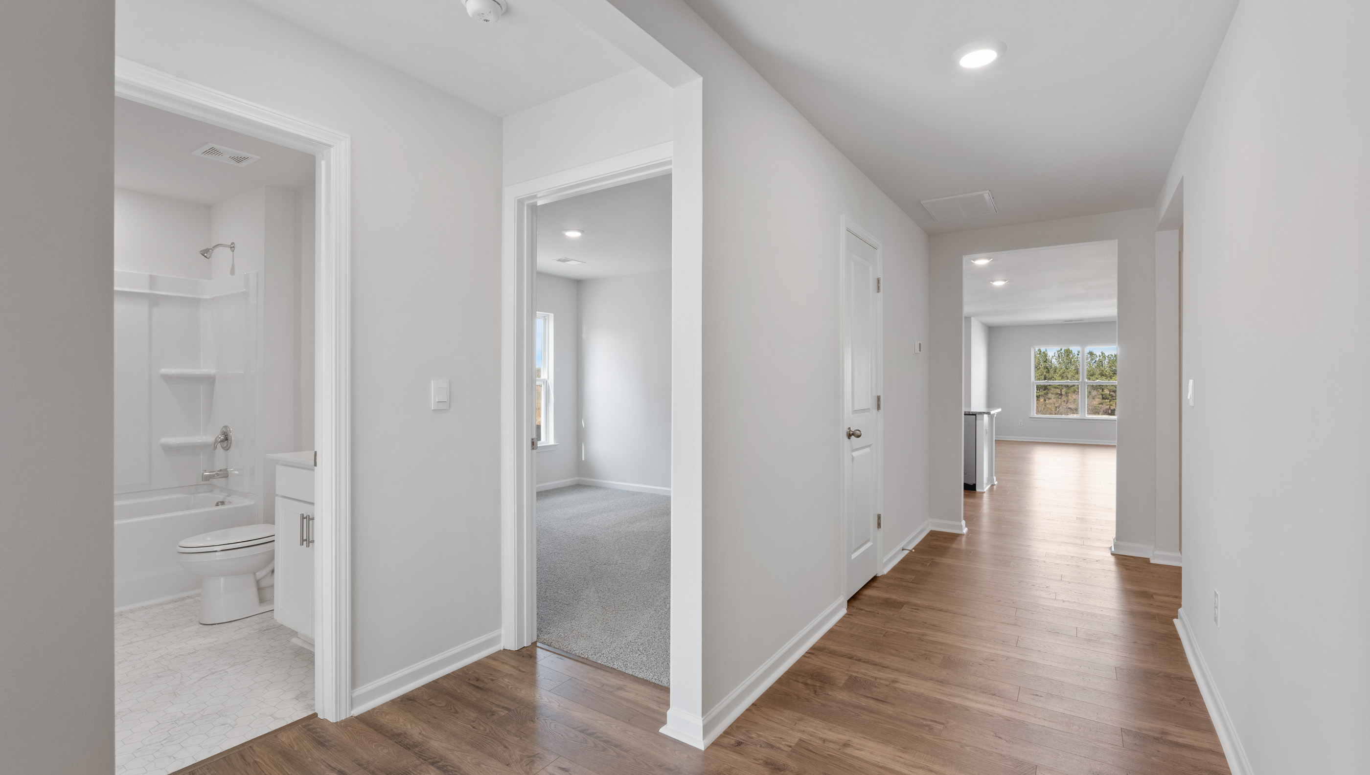 Hallway into home with view of rooms.