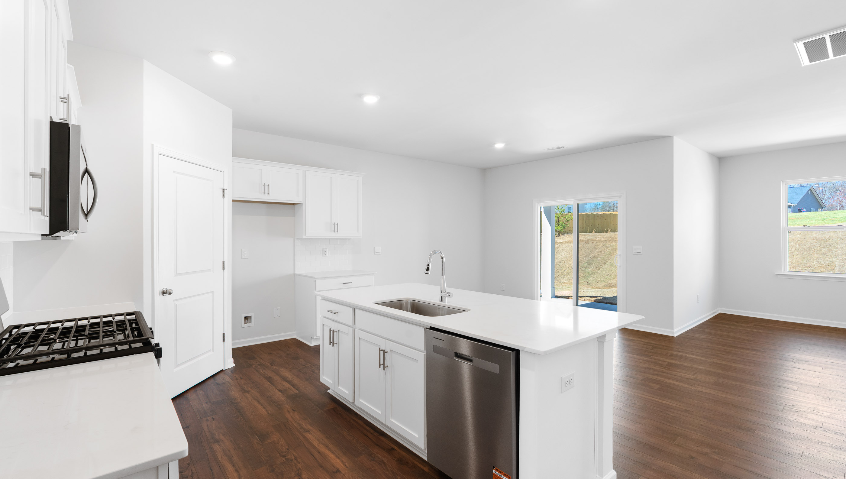 Kitchen with island and quartz countertop.