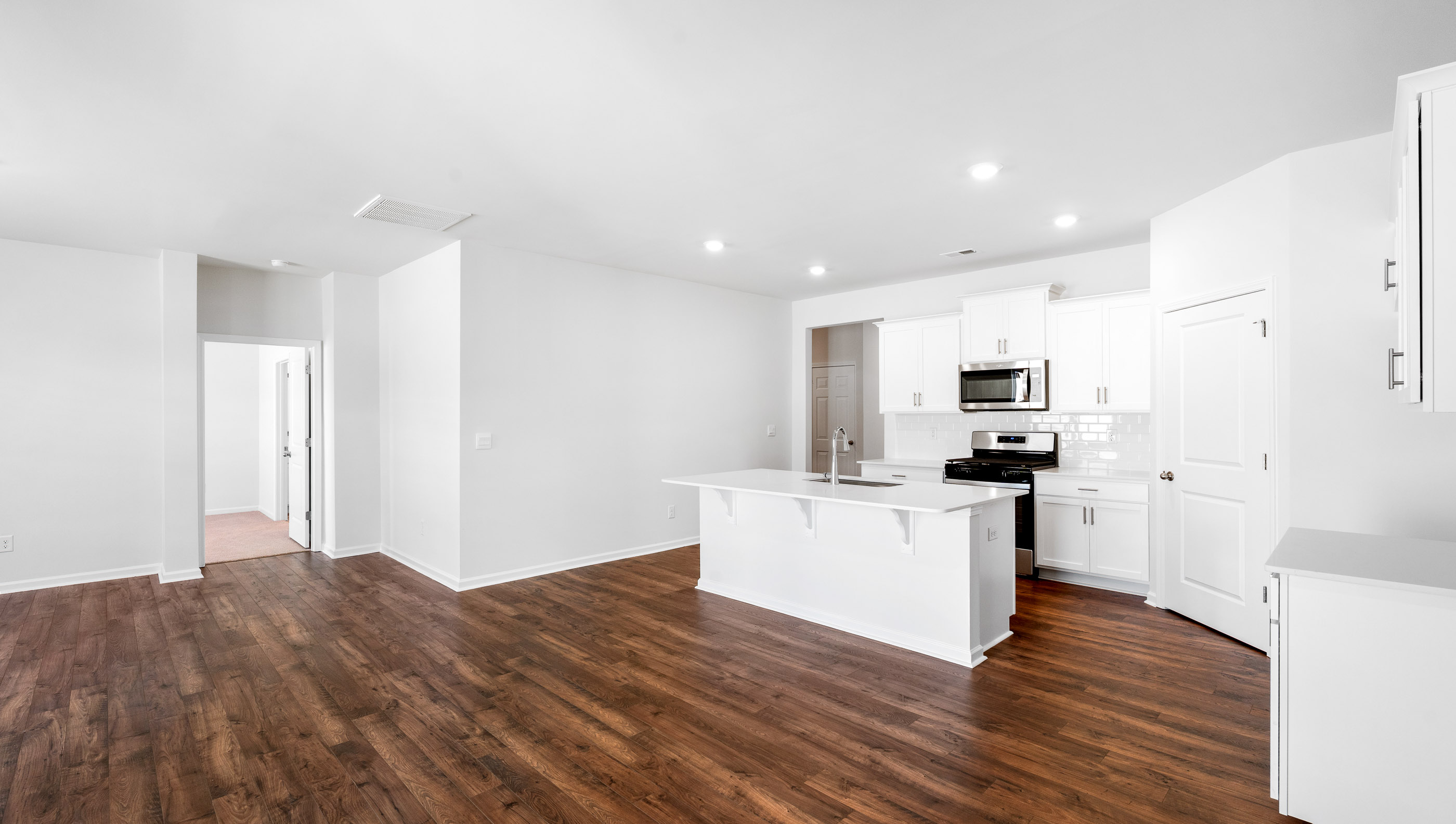 Kitchen with island and quartz countertop.