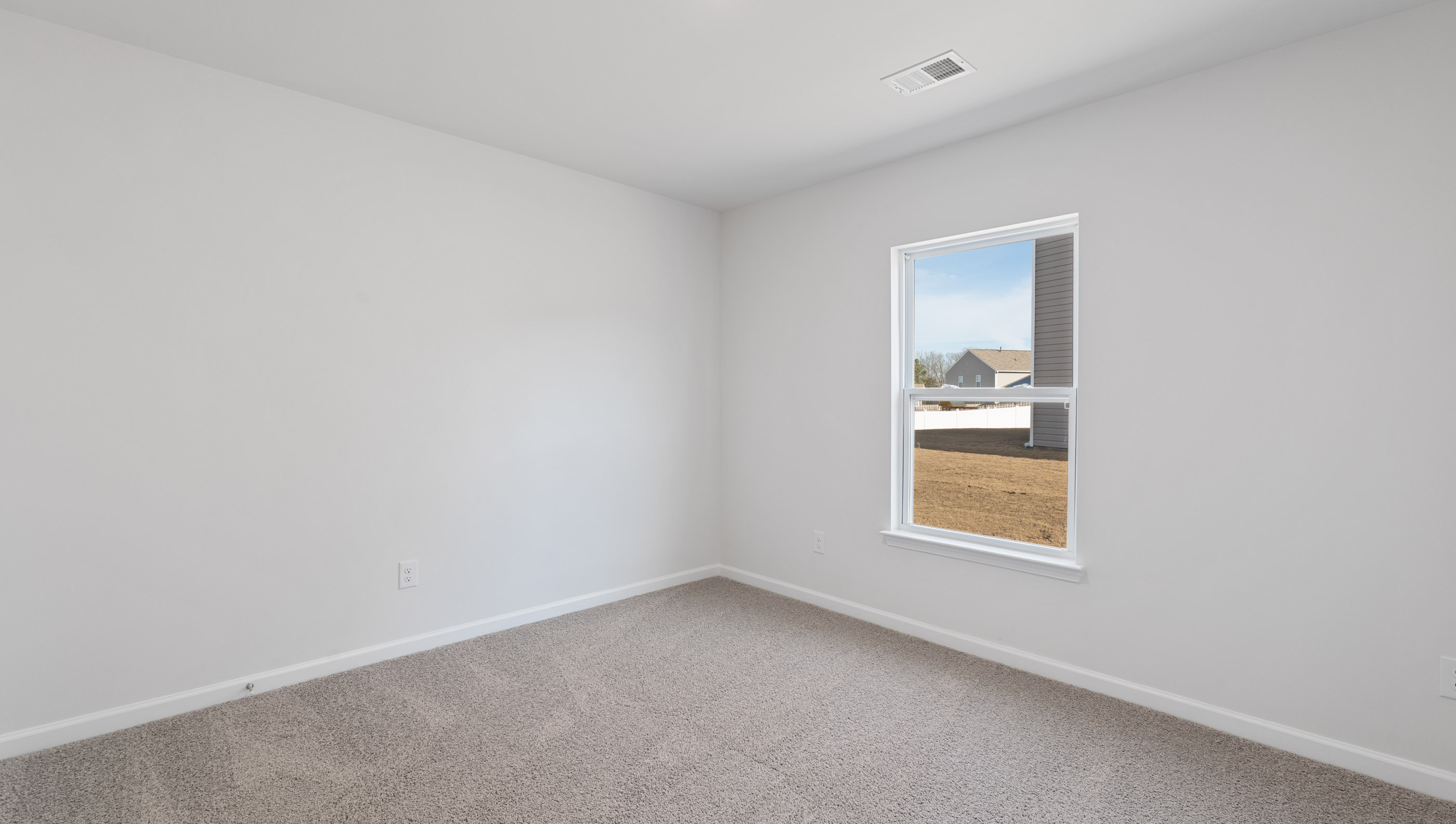 Bedroom with carpet and window.