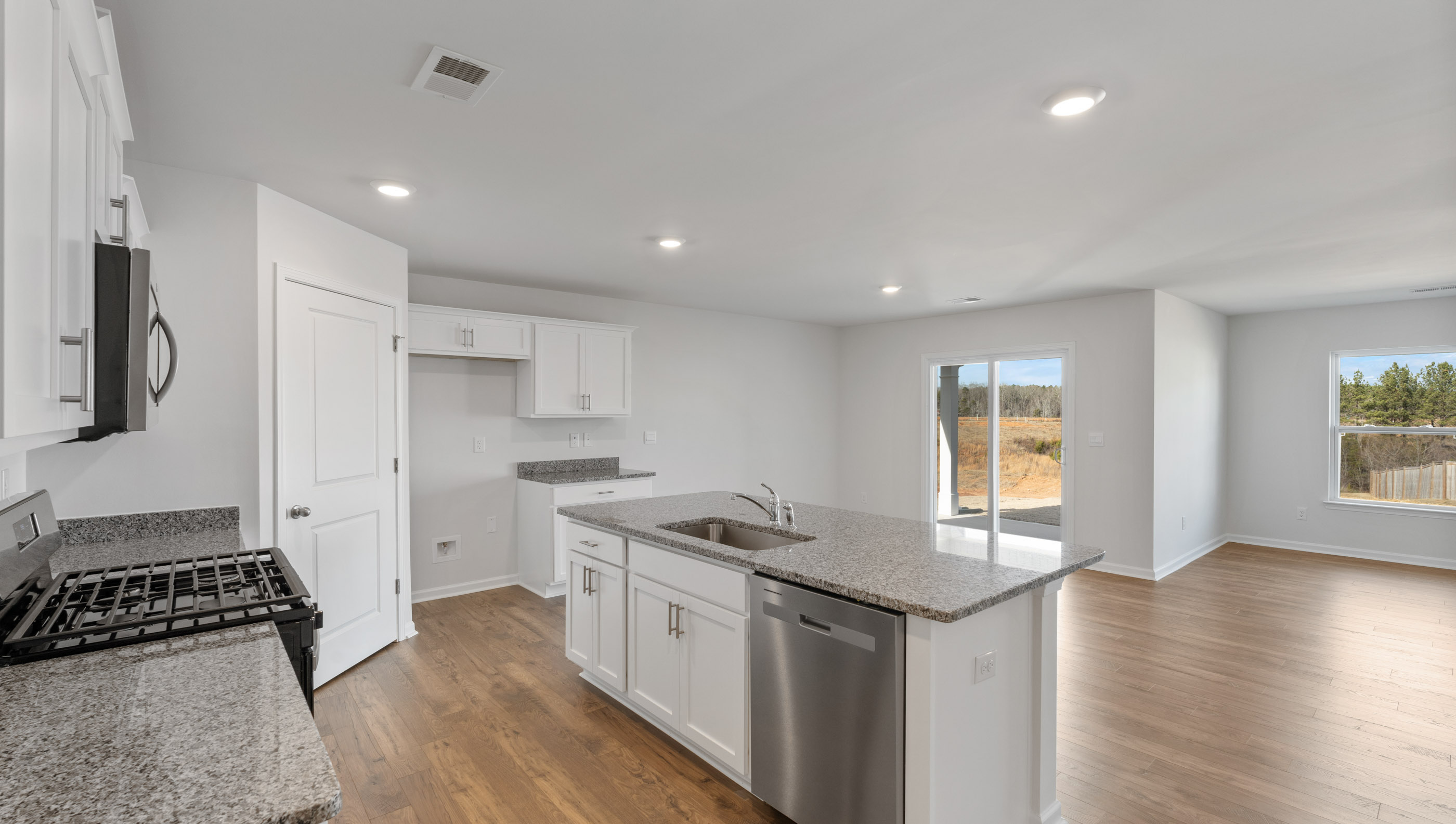 Kitchen and island with granite counter tops.