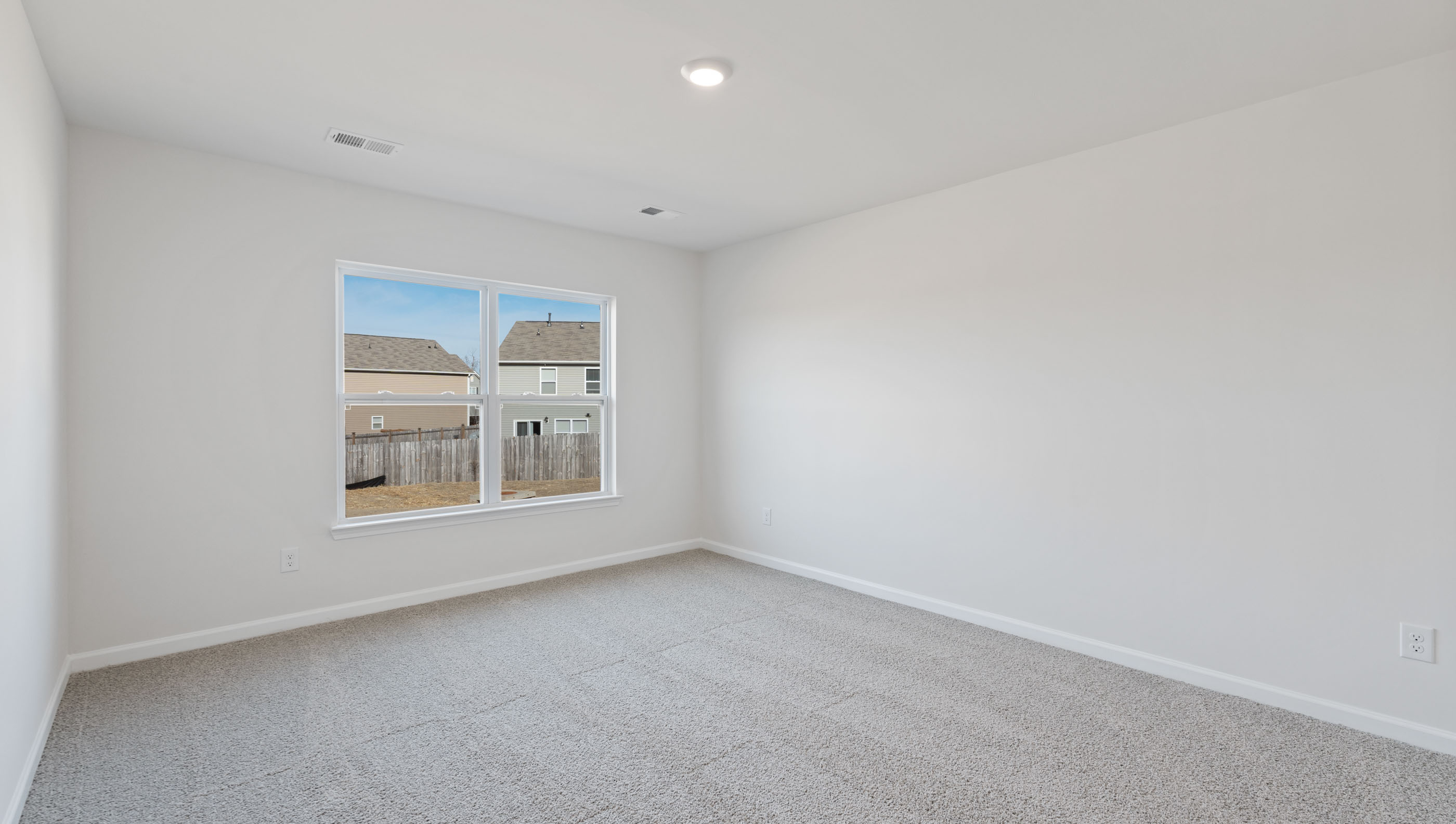 Bedroom with carpet and window.