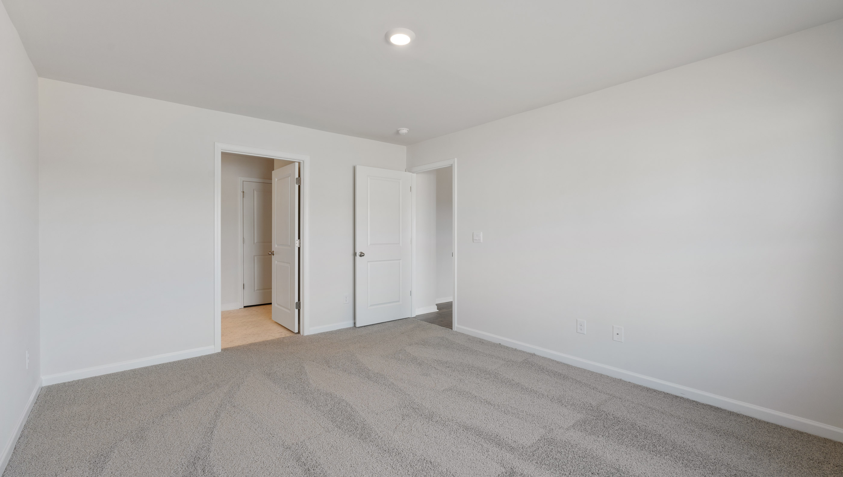 Bedroom with carpet and window.