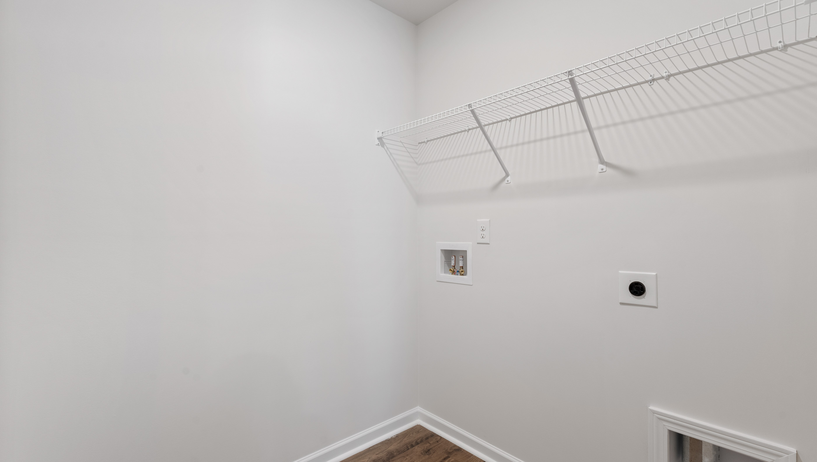 Laundry room with hanging storage racks.